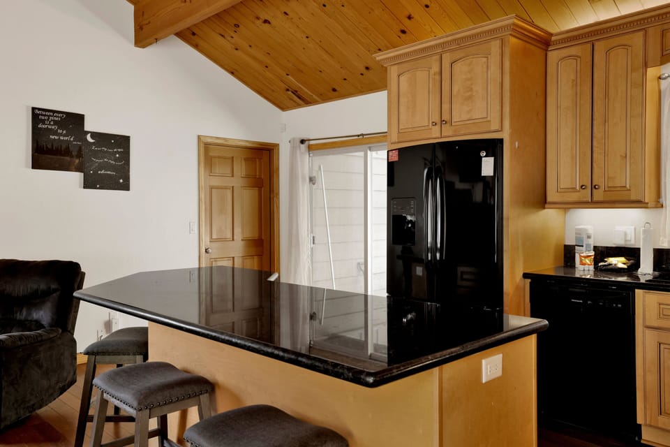 Warm kitchen space with a large island, comfortable seating, and a cozy atmosphere perfect for casual meals and gathering indoors.