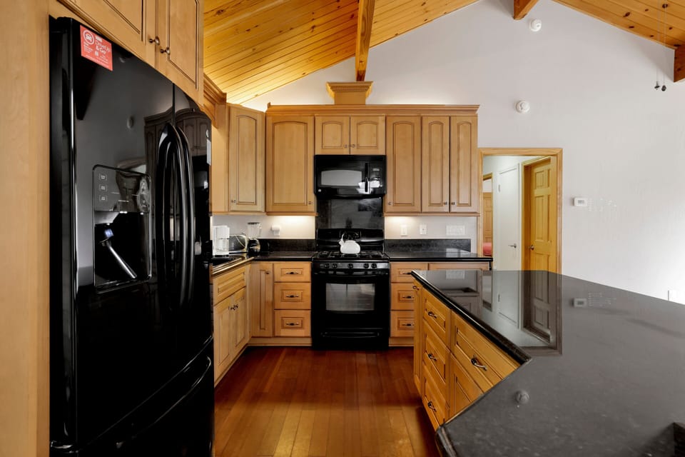 Fully equipped cabin kitchen with ample cabinetry, stove, fridge, and coffee maker—perfect for cooking meals, morning coffee, and feeling right at home on your stay.