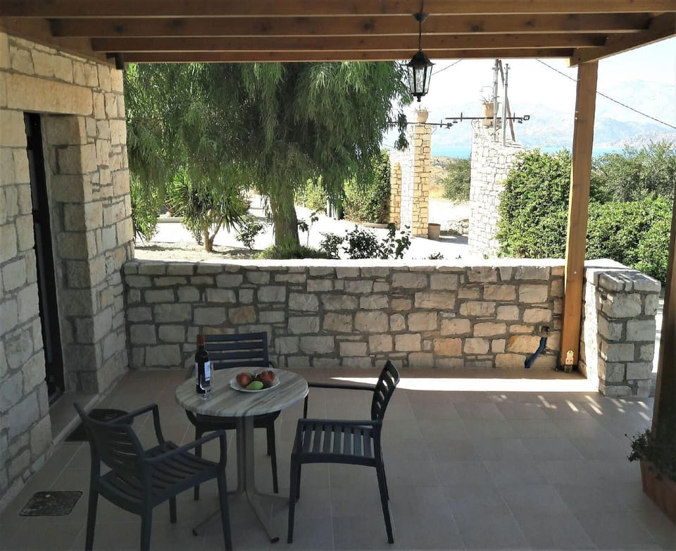 External view of the building. The cozy terrace with garden furniture with partial sea view