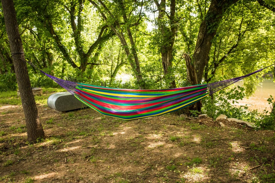 Firepit, hammock, and seating area down by river access