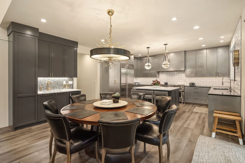 Dining Table with seating for 8 plus 2 more with extra stools in kitchen.