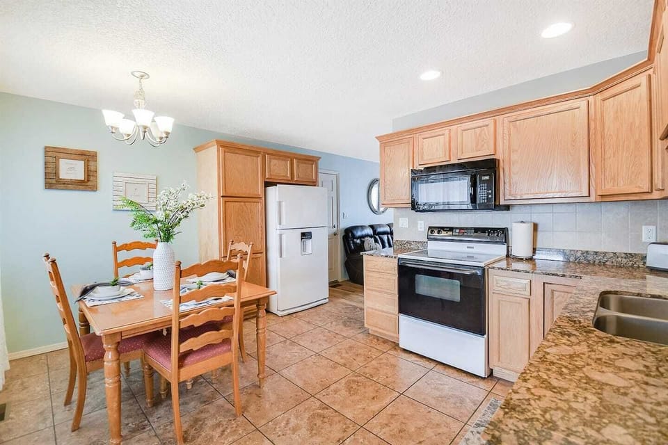 Kitchen includes refrigerator, electric stove, microwave, dishwasher and coffee maker