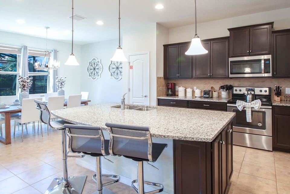 Modern kitchen with dark cabinetry and stainless steel appliances