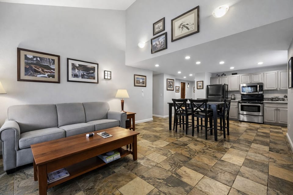 Open-concept living area with a modern fully-equipped kitchen, dining space, and comfortable seating. Perfect for socializing and unwinding after a day on the slopes.