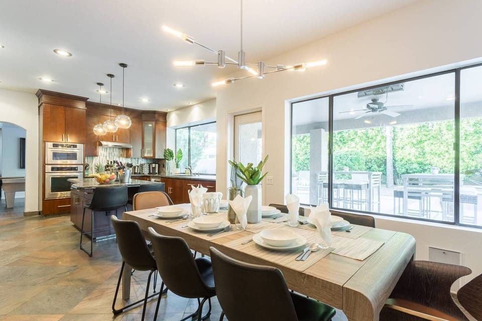 Large dining room table near kitchen.