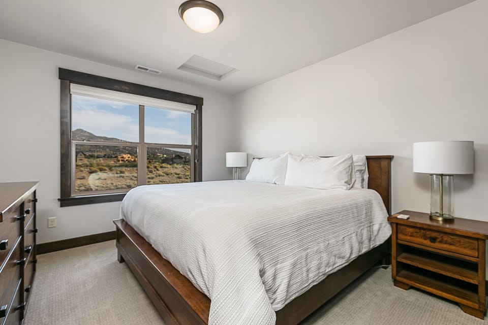 Second upstairs bedroom with king bed and view of buttes and ponds