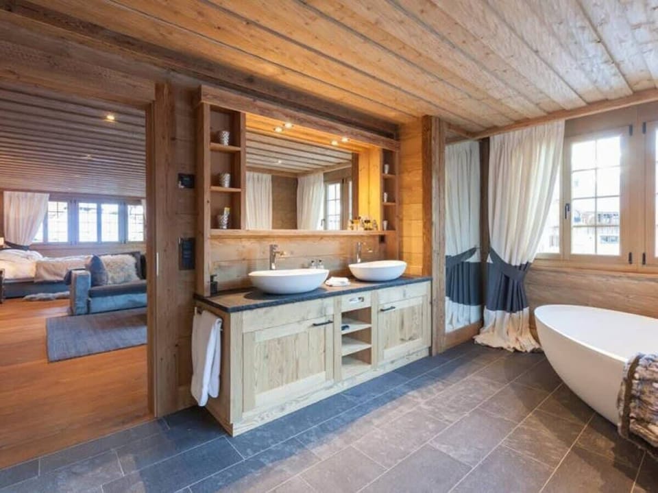 bathroom in master bedroom 1 with large bathtub 