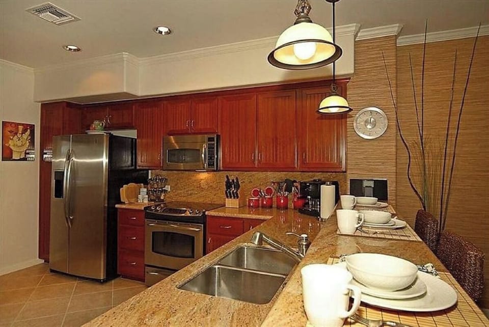 Beautiful modern kitchen with bar seating and fully stocked kitchen