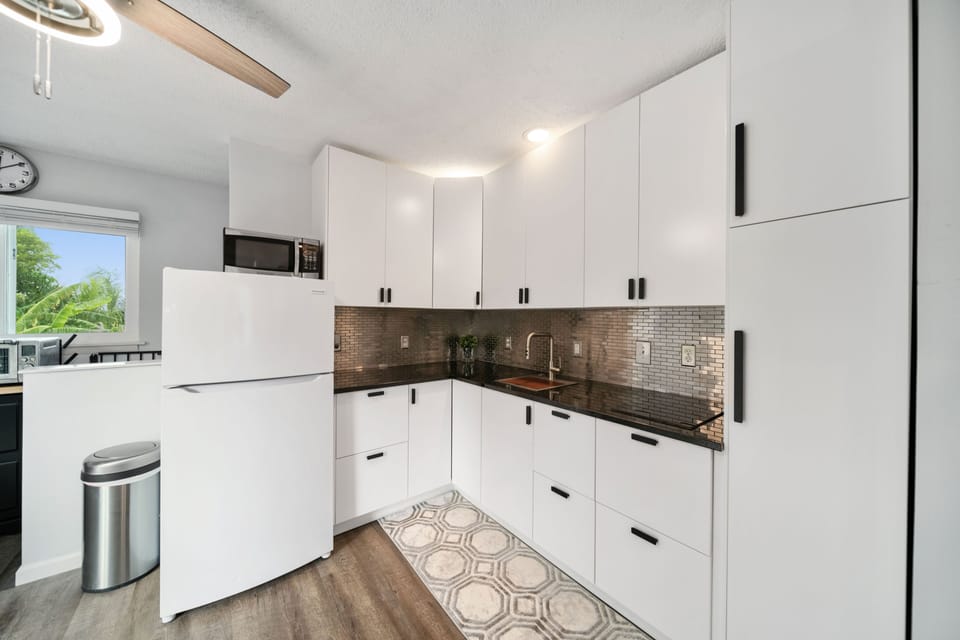 Beautiful kitchen with stainless steel backsplash and garbage disposal