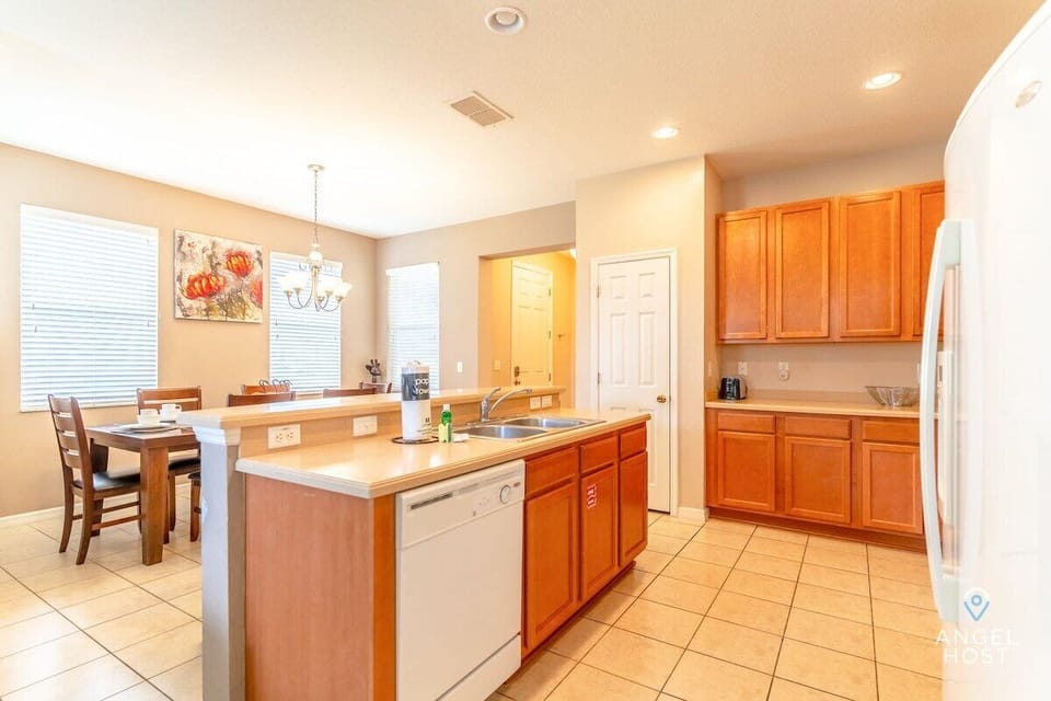 Fully-equipped kitchen for home-cooked meals and bar top with barstools.