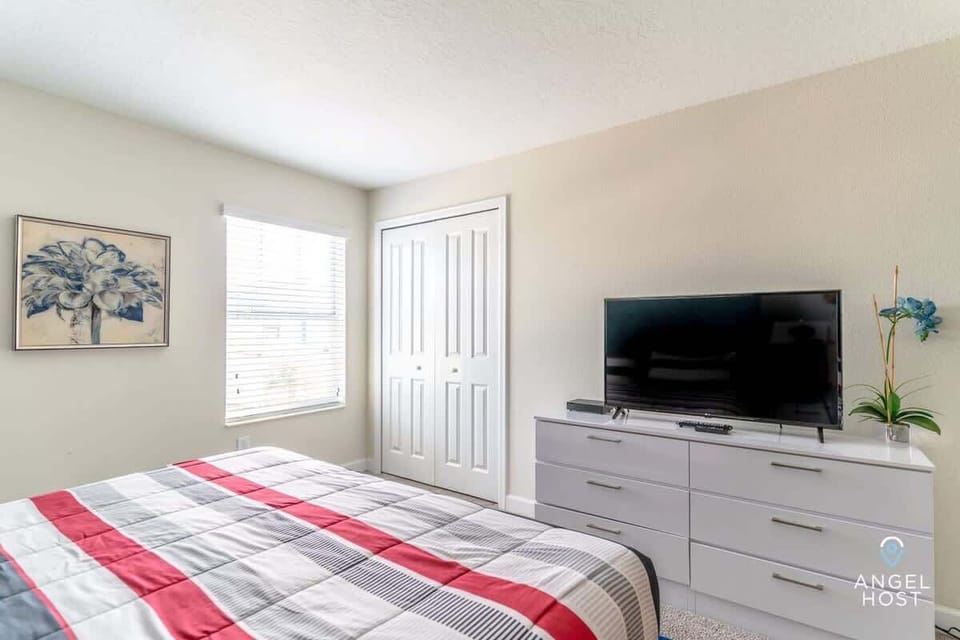 Enjoy Bedroom 5, furnished with a king-size bed and a TV for your comfort.