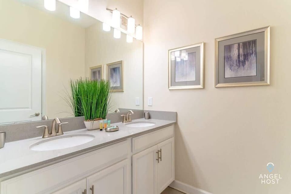 Bathroom 2 features a spacious two-sink vanity and modern lighting.