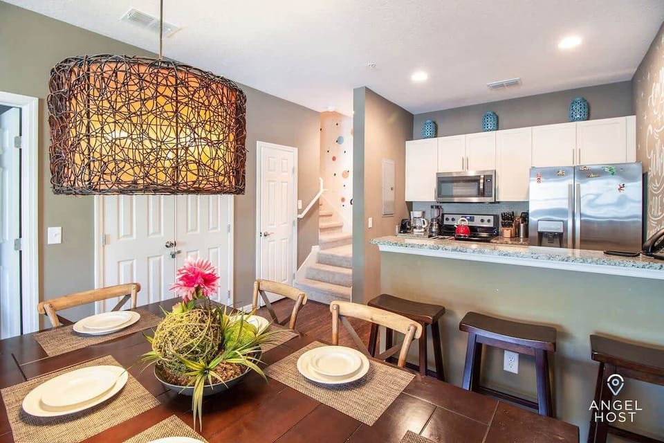 Bright kitchen and dining area with breakfast bar for gathering together.