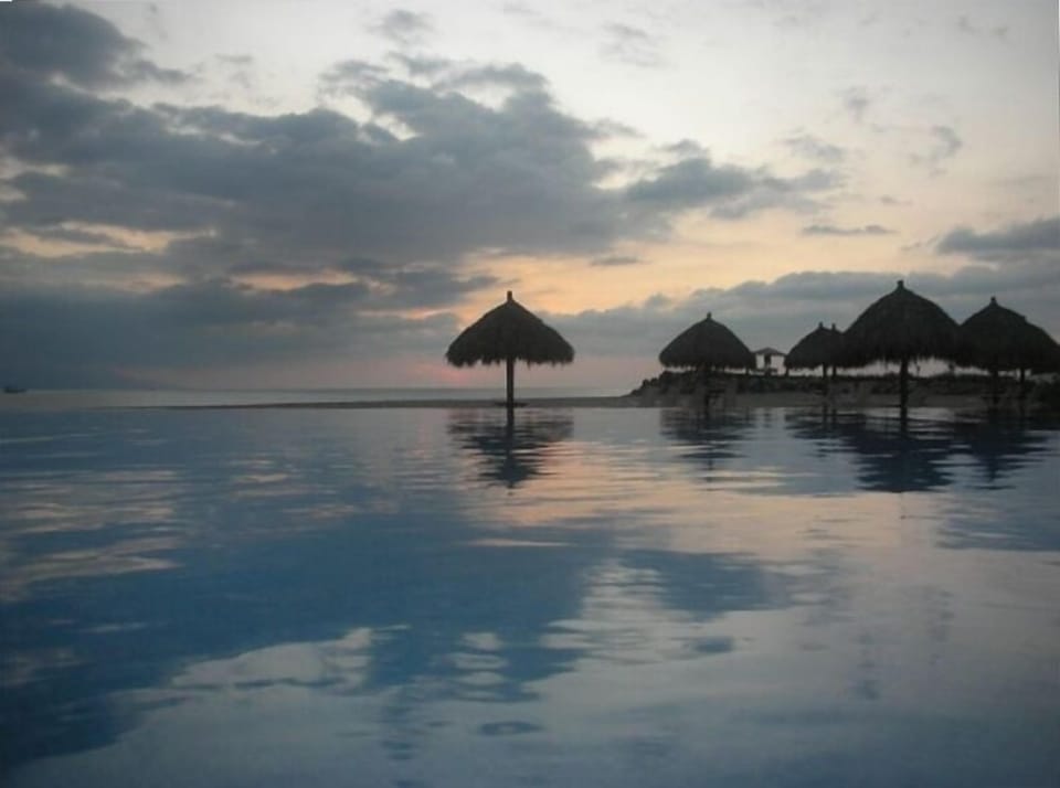 Infinity pool in forefront looking out to Condo's private beach.