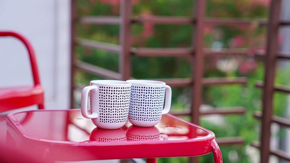 Red themed balcony perfect to enjoy morning coffee in. 