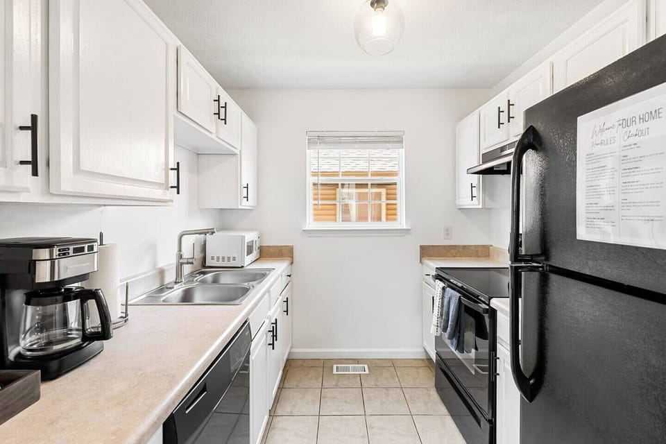 Our galley style kitchen features a Fridge and freezer, stove and oven, microwave, coffee maker, dishwasher, double sink, pots, pan, cooking utensils, culinary knives, toaster, full dining sets, and more!.
