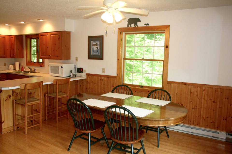 Dining room table seats 8 (more chairs available) and 2 more at island counter
