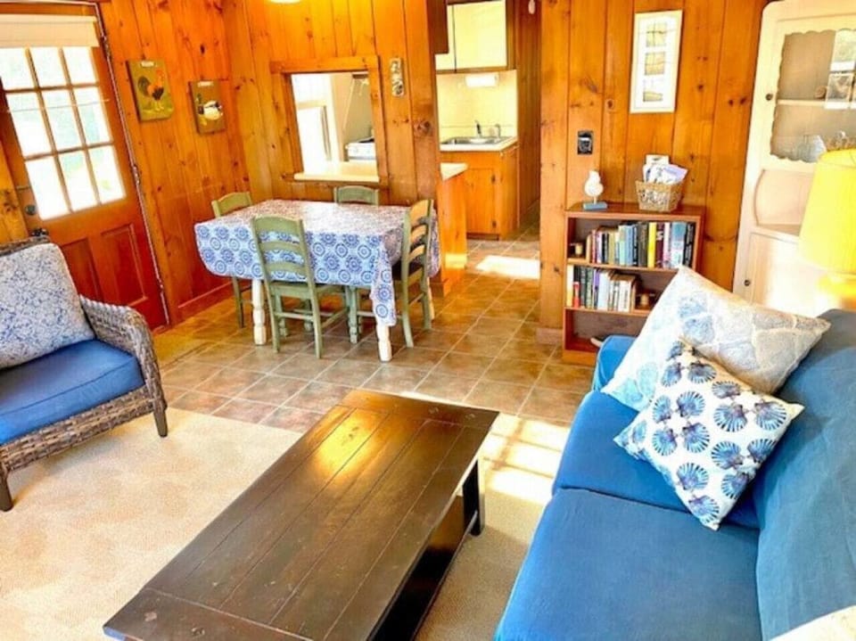 Dune Suite living room with view to dining area and fully-equipped kitchen.
