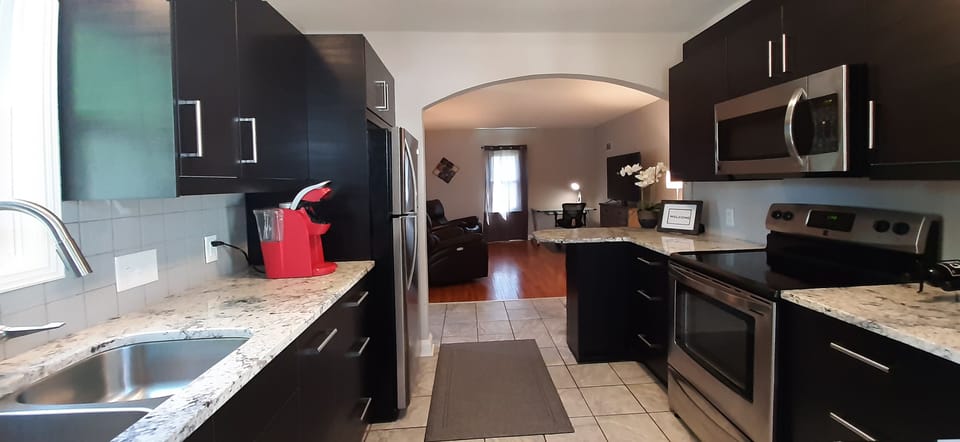 Fully equipped kitchen with granite counters and Keurig® coffee maker.