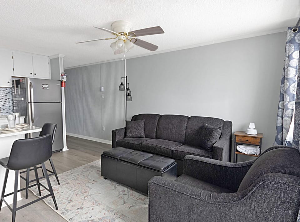The cozy living room has a sleeper couch for additional sleeping capacity.