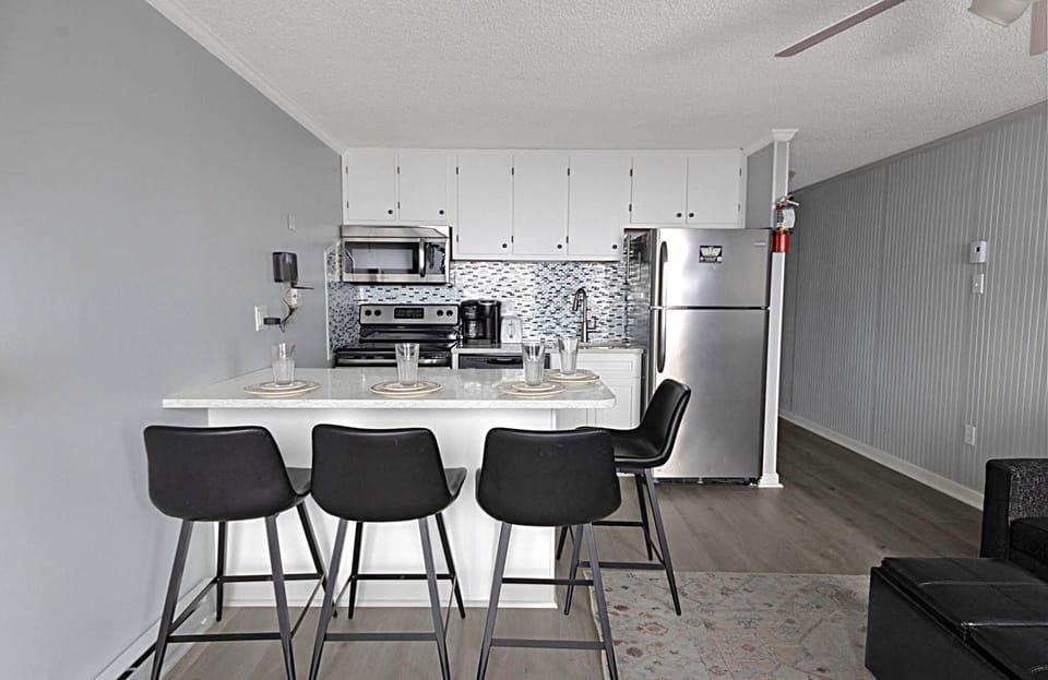 The kitchen island, with granite countertop, sits four people.