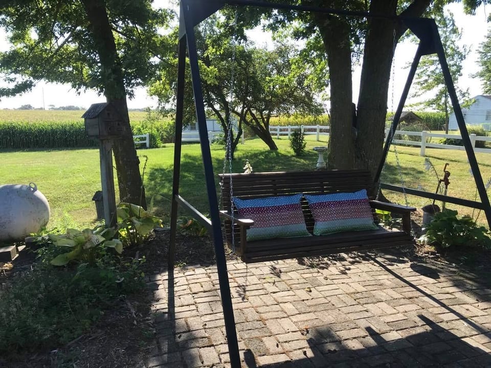 Porch swing on back patio. Other outdoor seating available.