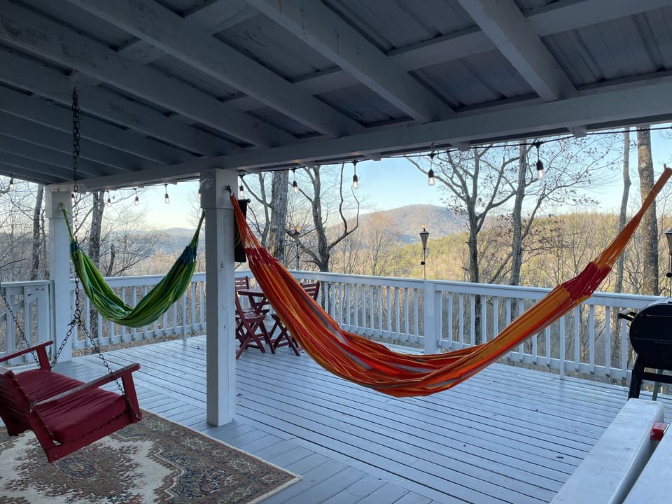 A large porch with colorful hammocks to enjoy the beautiful Mountain View