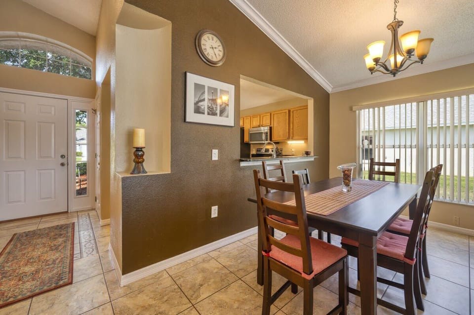 Formal dining area with kitchen serving/viewing window.