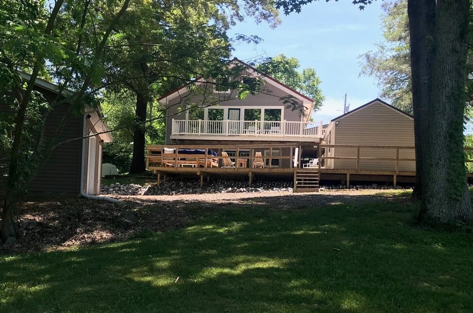 Back of the home facing large private yard 