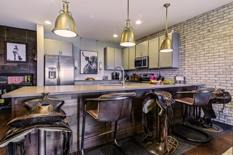 Pull Up a Genuine Horse Saddle Bar Stool, or Relax in a Rustic and Iron Scoop Seat Option.  Bar Seating for 5 Offered at our counter. In LOVE with this Bar Seating!