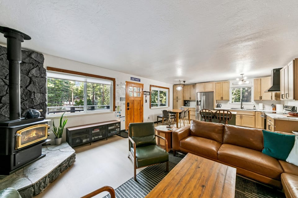 Spacious living room with cozy wood stove and garden views