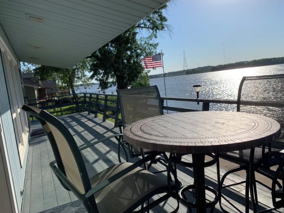 Balcony with table and 4 high chairs.