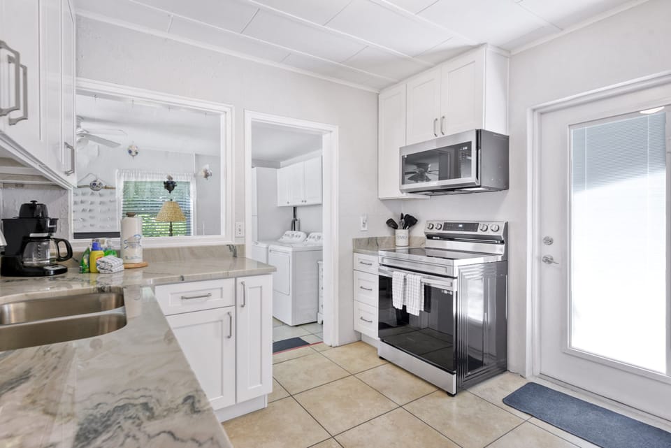 Newly updated kitchen with new stainless dishwasher, microwave and smooth top electric range
