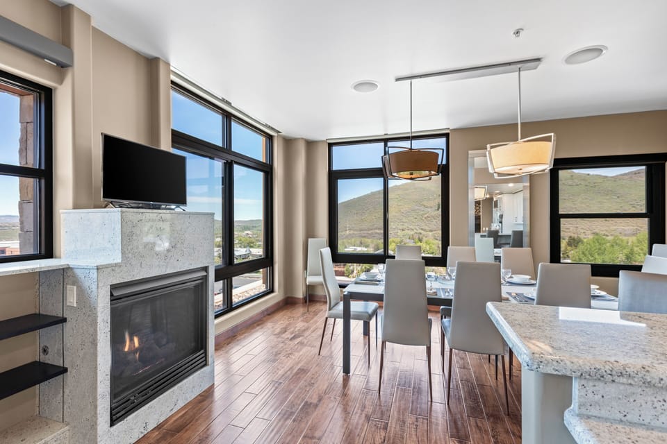 The Lowell 401 dining table has place settings for 8 guests and has floor to ceiling windows on two sides of the table.