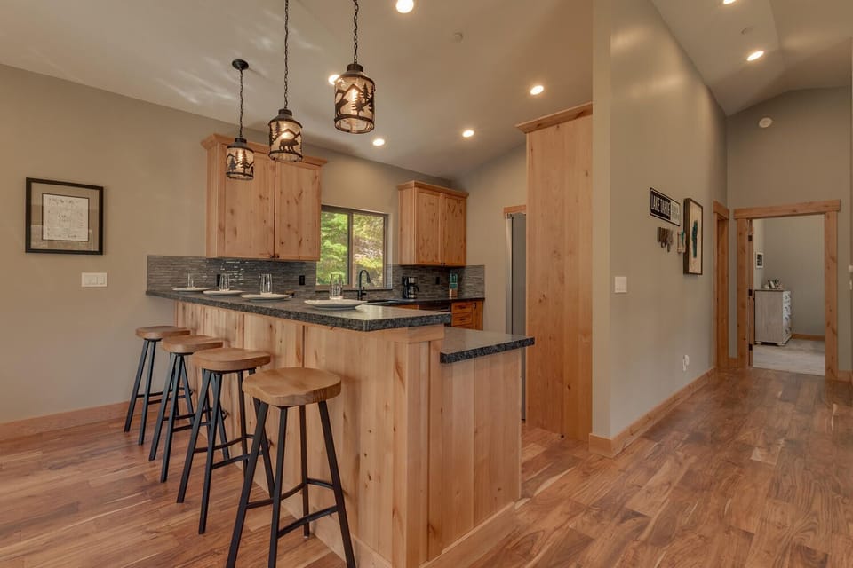 - Modern kitchen with rustic wood cabinetry  
- Granite counters and bar seating for four guests  
- Perfect for cooking and socializing in Tahoe