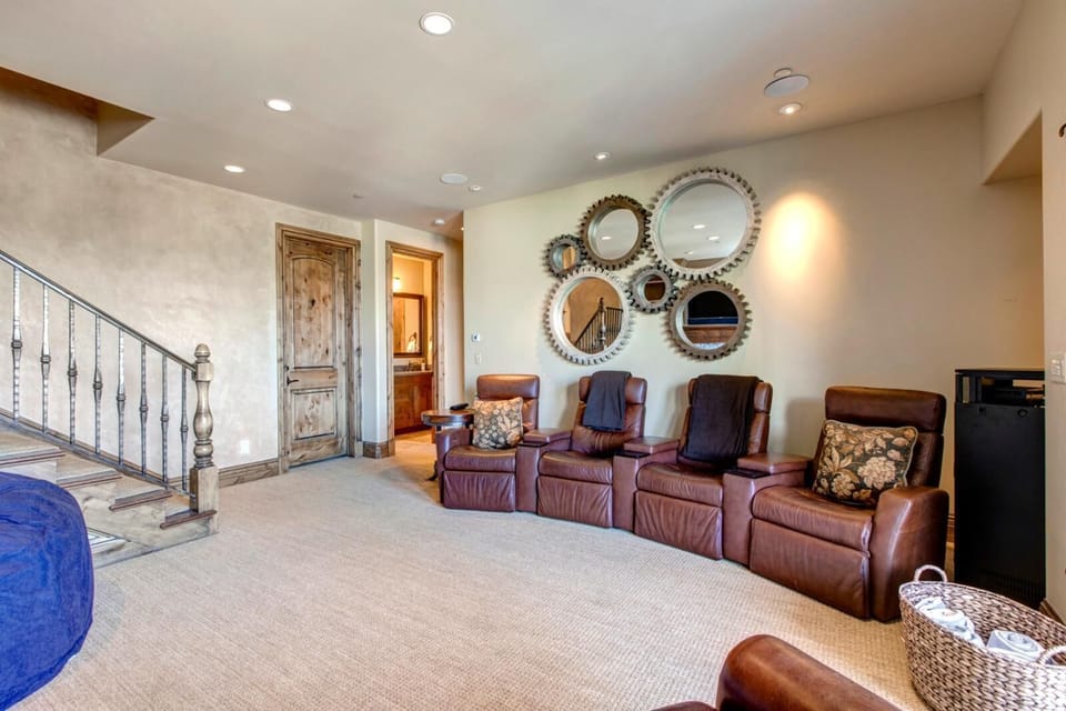 Downstairs entertainment room features Smart TV, oversized sofa, and space to unwind as a group.