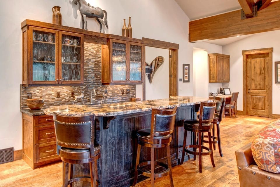 Gather for appetizers or cocktails at the kitchen bar with seating and stylish lighting.
