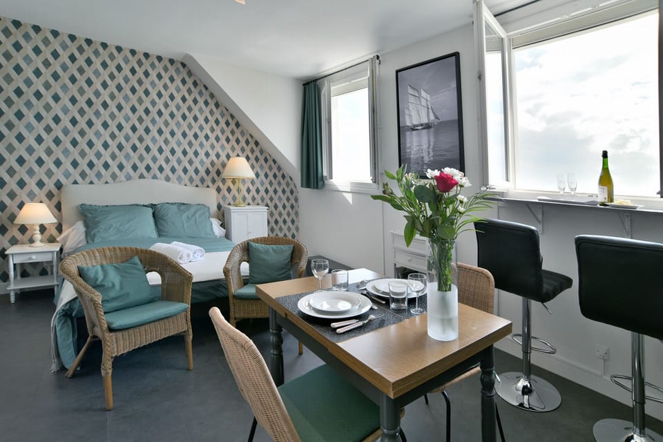 Studio - living room with dining area and sleeping area