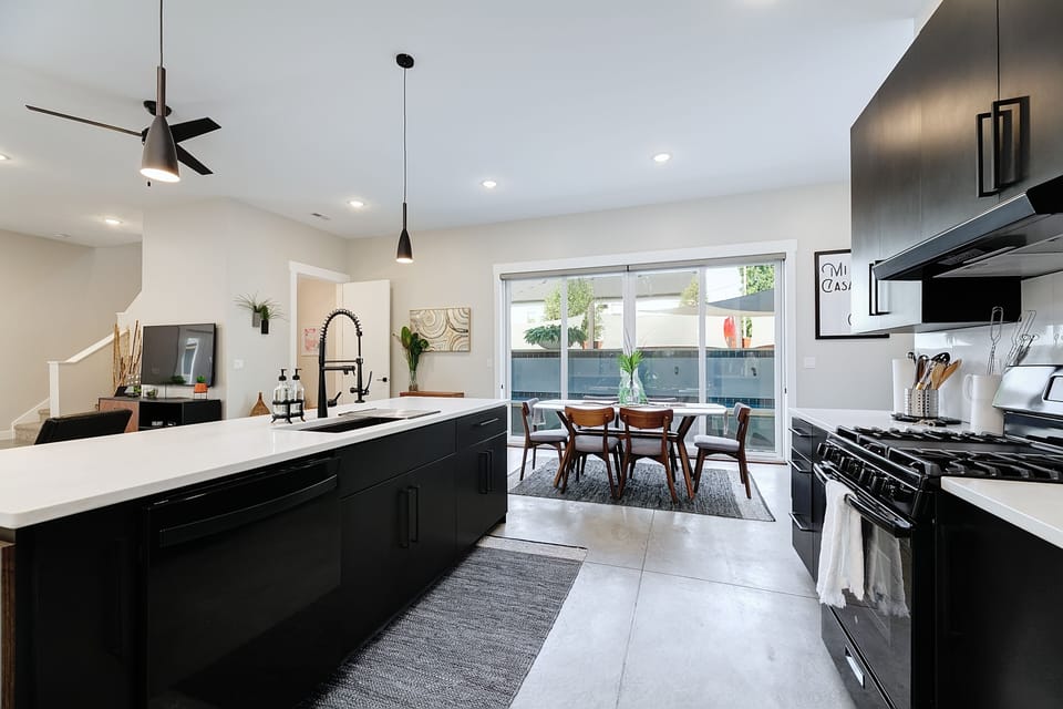 Our kitchen has black stainless steel appliances accented by white counters!
