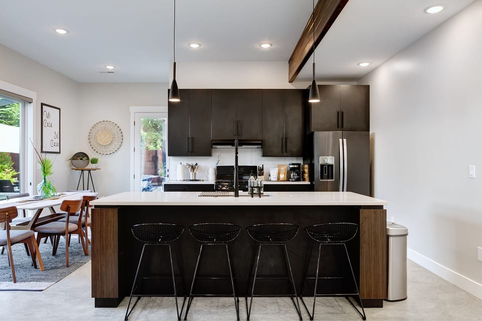 Stylish black cupboards complement this cooking island featuring seating for 4. 