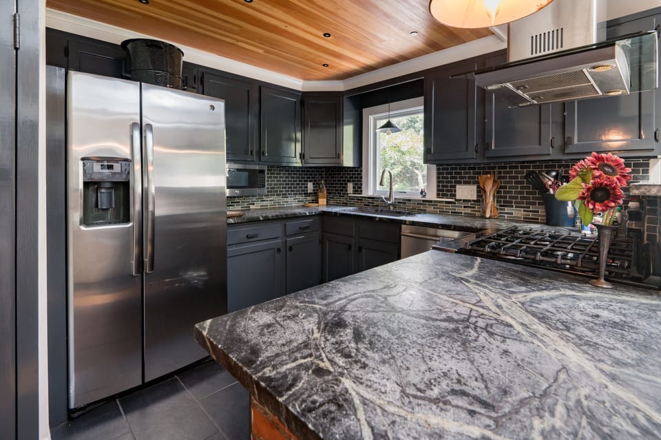fully stocked chefs kitchen with soapstone counters