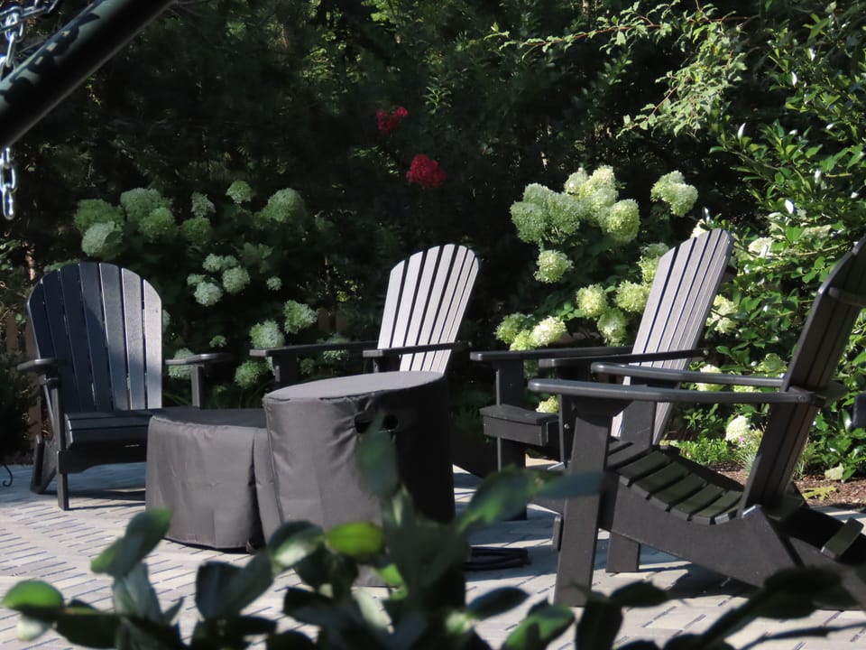 adirondaks around fire pit and near gardens surrounding the pool