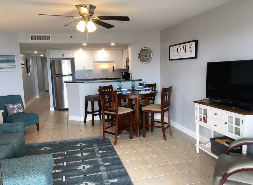 Living and dining area, seating for 4 at the table.