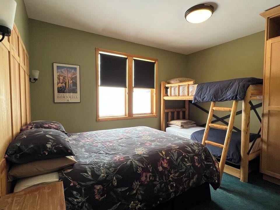 Middle level bedroom with queen bed and bunk beds.