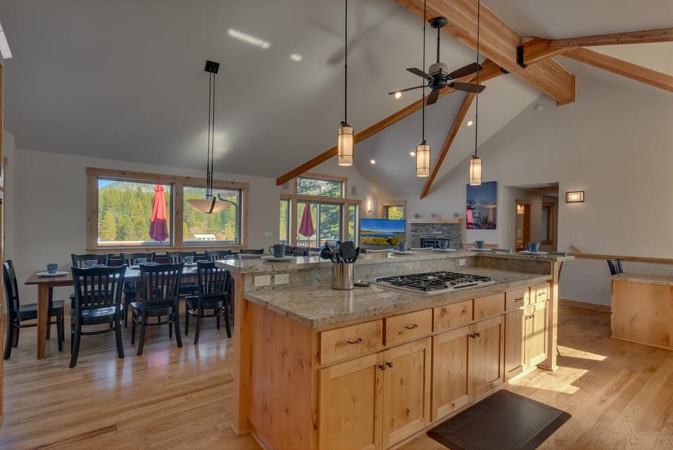 - Kitchen island with barstool seating  
- Granite counters and pendant lighting  
- Tahoe cabin rental with chef-style kitchen