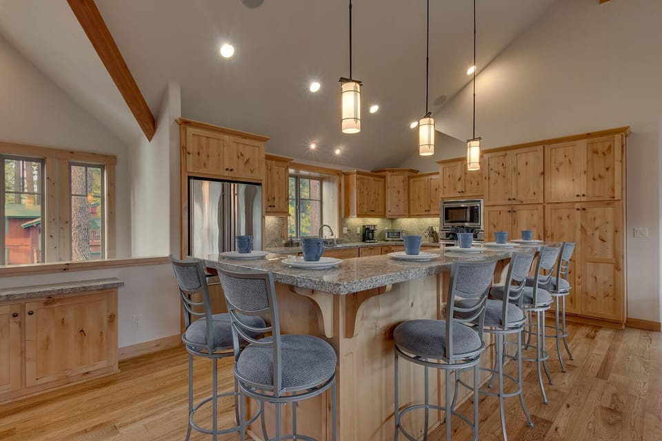 - Spacious kitchen with wood cabinetry  
- Stainless appliances and stone counters  
- Tahoe cabin rental with modern amenities