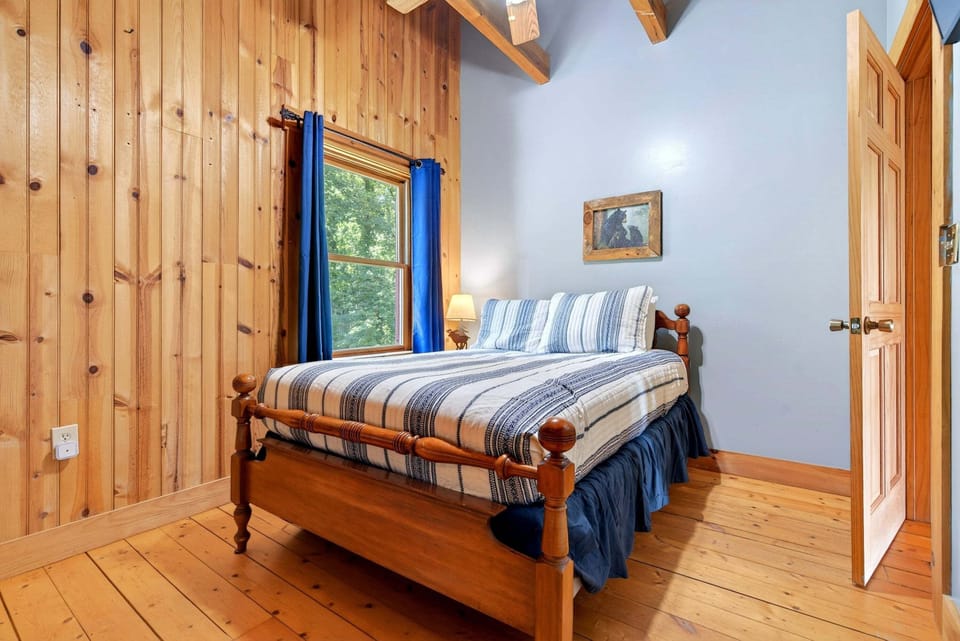 Upper-level bedroom with a Twin bunk bed, a Full bed, and a Smart TV.