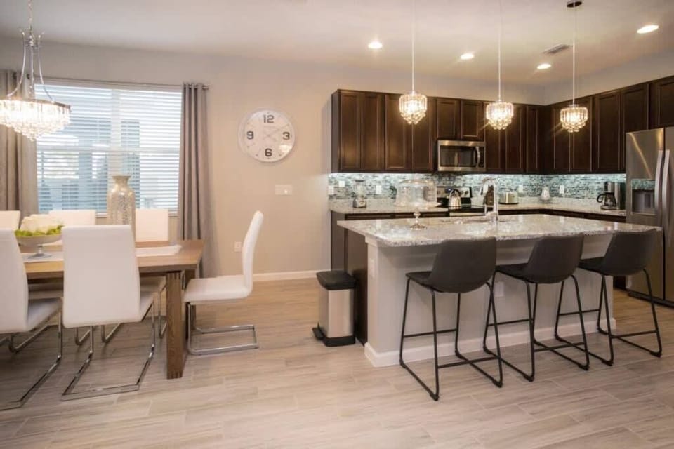 A breakfast bar with extra stool seating at the kitchen counter.