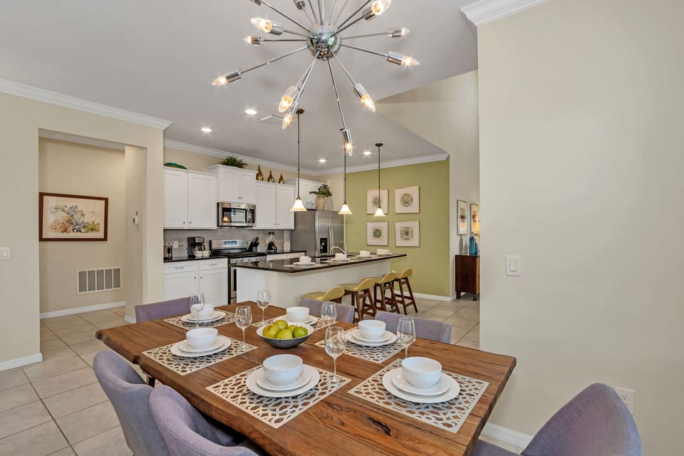 Alluring dining area of the home in Davenport Florida - 6 Persons dining - Chic dining area featuring a stylish table and contemporary seating - Open layout seamlessly connecting the dining area to the kitchen