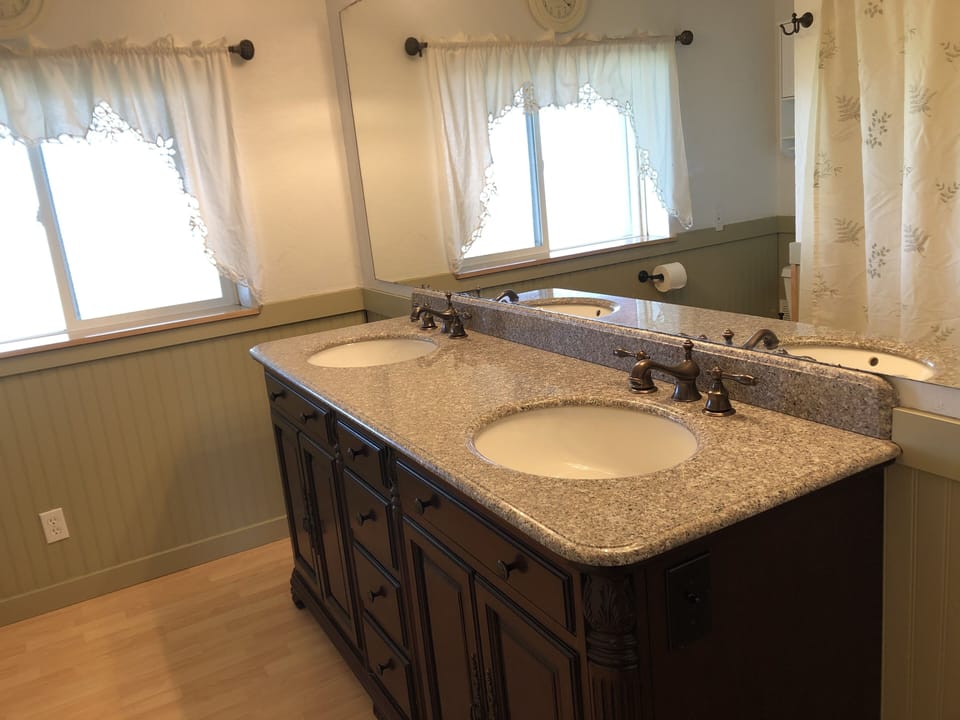 Bathroom #1 with tub, shower, and double sink vanity